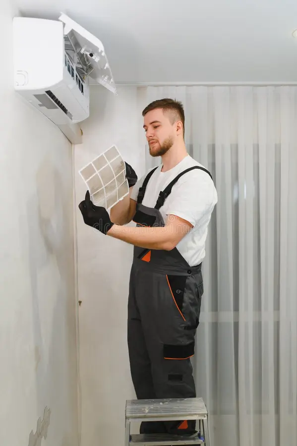 technician cleaning air conditioner filter maintenance service hvac technician inspecting dirty air conditioner filter 450906502